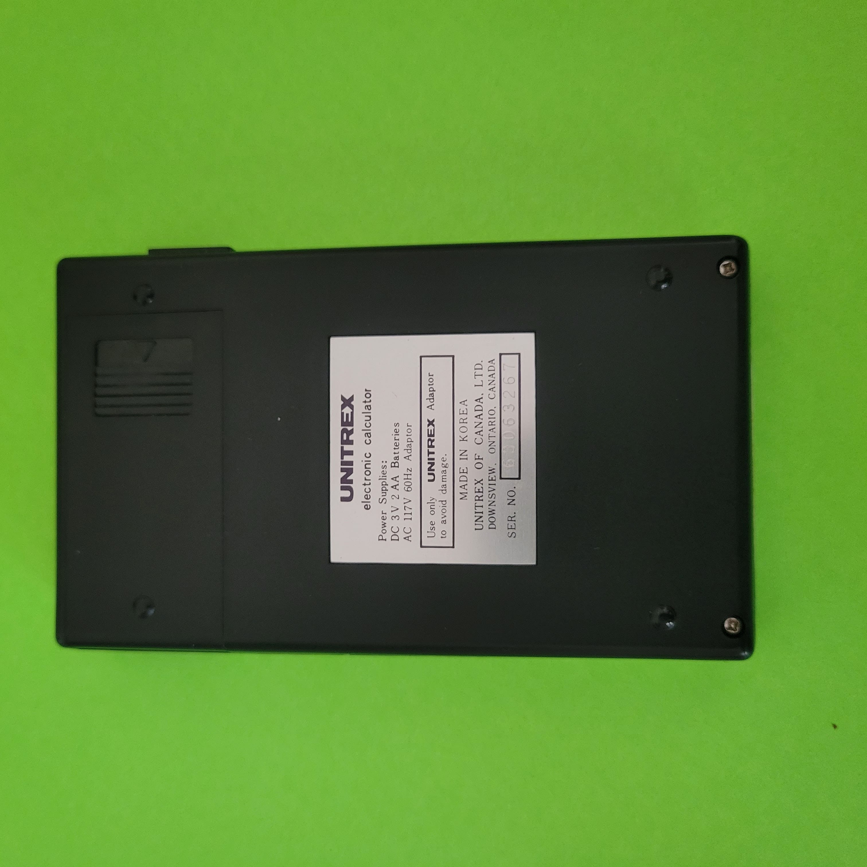 An image of the back of a Unitrex 809D Four function plus calculator